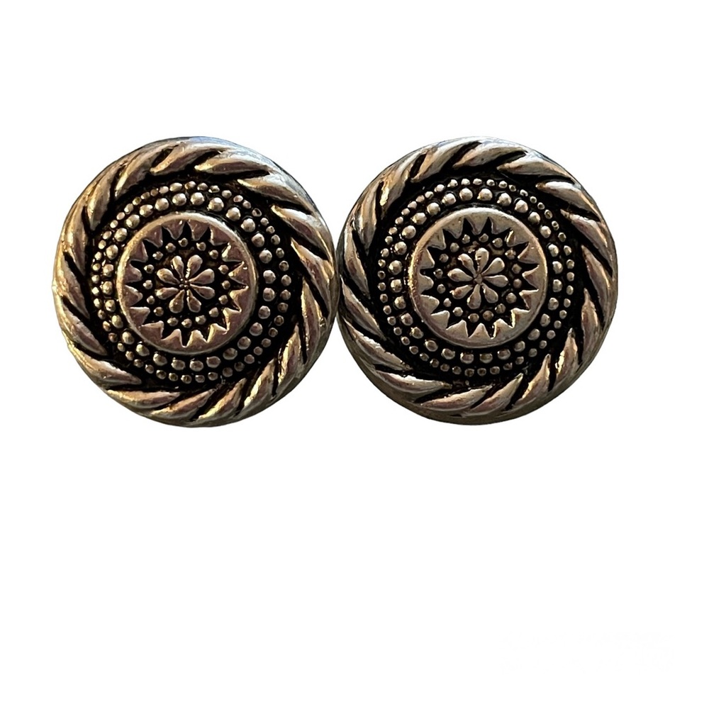 Silver toned hollow pierced earrings with floral/rope design.